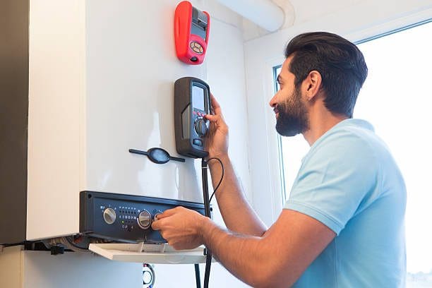 Picture of an engineer checking a domestic boiler | Letsgo TNT Gas & Heating Engineers